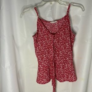 Red blouse with string in front it has white flowers